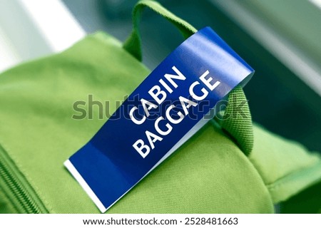 Cabin baggage close-up of tag on green backpack at the airport	