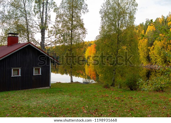 Cabin By Lake On Autumn Evening Stock Photo Edit Now 1198931668