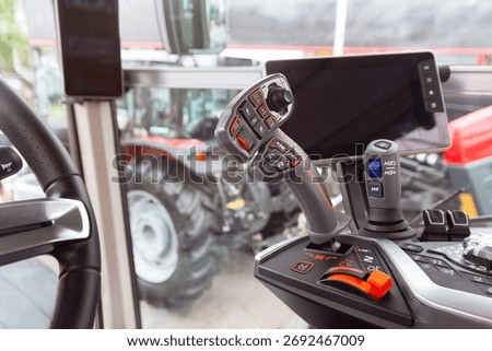 The cabin and control stick tractor of a modern tractor close-up. Industry