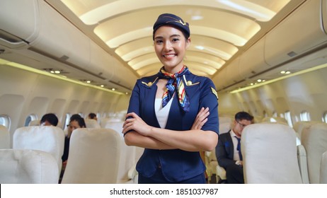 Cabin crew or air hostess working in airplane . Airline transportation and tourism concept. - Shutterstock ID 1851037987