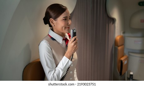 Cabin Crew Or Air Hostess Working In Airplane . Airline Transportation And Tourism Concept. Flight Attendant Waiting For The Passengers To Board