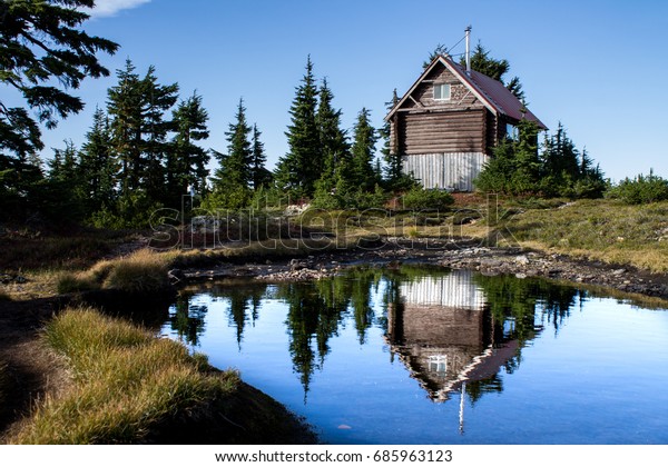 Cabin On Mountain Reflecting Alpine Lake Stock Photo Edit Now