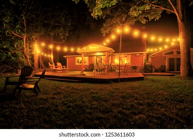 Cabin Patio Lit Up With String Lights At Night.