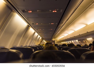 Cabin Plane Passengers On Seats Waiting To Take Off