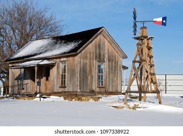 Cabin In The Snow With Texas Flag Windmill