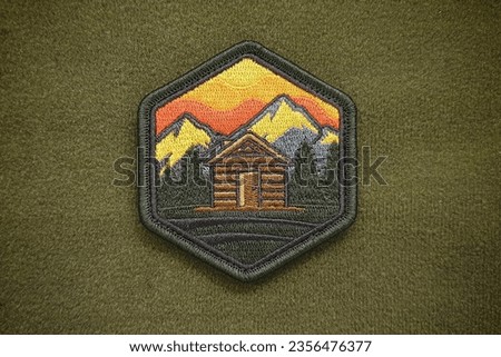 The cabin sunset morale patch is a velcro patch used for attaching to clothing and bags.