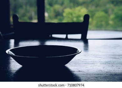 Cabin table in front of window overlooking forest