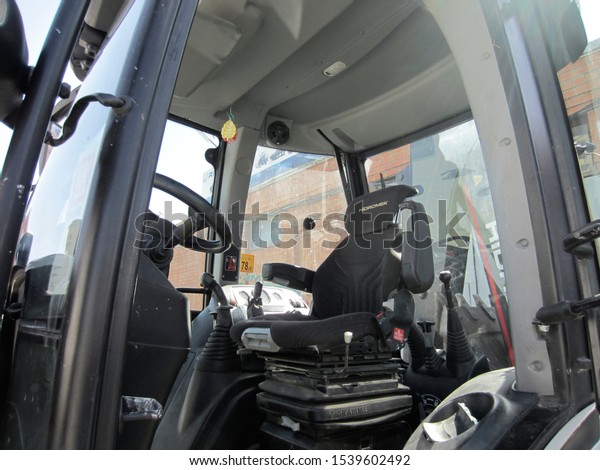 Cabin\
of turkish backhoe loader  Hidromek in a parking lot for road\
transport, Krasnodar region, Russia, April 6, 2016. Steering wheel\
and driver\'s seat for managing freight\
transport.