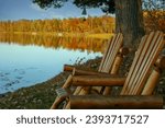 Cabin view of calm lake reflection with brightly autumn colored shoreline in the Chippewa National Forest, northern Minnesota USA