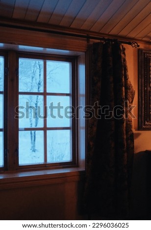  cabin window with view on a snow covered landscape