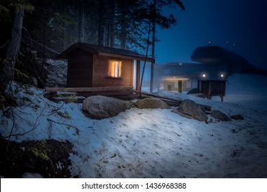 Cabin In The Woods With Snow Around At Night