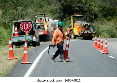 CABLE BAY, NZ - DEC 12 2013:Road Worker Arranging Cons On A Road Work Site.The Road Maintenance Crew Has The Responsibility For The Day-to-day Maintenance Needs Of The Road System.