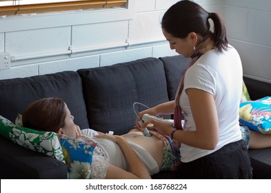 CABLE BAY,NZ DEC 2013:Midwife checks baby heart beat and movement.Midwifery is a health care profession in which providers offer care to women during pregnancy,labor ,birth and postpartum.