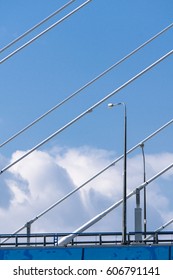 Cable bridge high in the clouds on a sunny day.