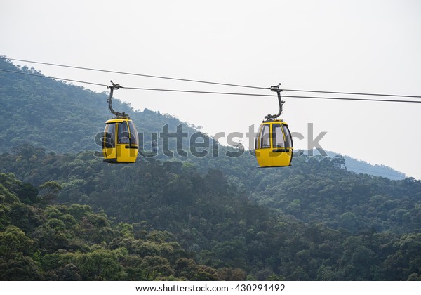 Cable car above hill\
forest