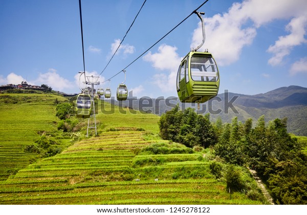 Cable car above\
the Longji Rice Terraces (Dragon\'s Backbone), one of the Guilin top\
tourist attractions,\
China.