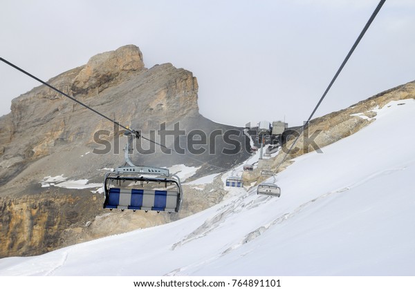 Cable car above snow\
mountain
