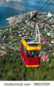 Cable Car Above Tromso City With The Bridge And Arctic Cathedral On Background, Norway