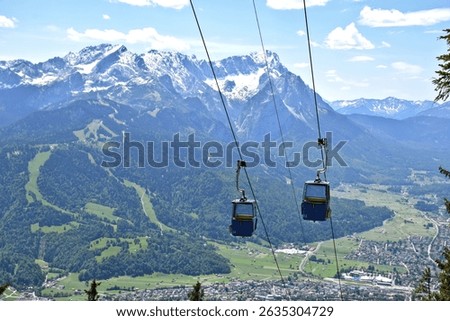A cable car ascends Mount Wank in Garmisch-Partenkirchen, offering panoramic views of the Bavarian Alps in the background. Germany.