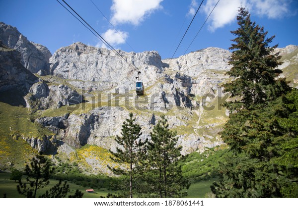Cable car in\
Asturias, Spain-05-25-2019 Cable car hung on steel cables in Picos\
de Europa to transport\
people