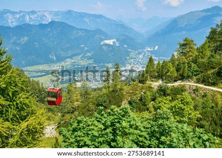 Cable car cabin with a panoramic view of Bad Ischl in the background.