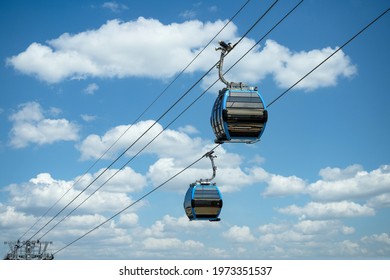 Cable car cabins against amazing sky and clouds. Cableway, green transportation. 