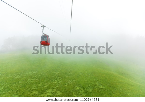 Cable car in\
the fog. Alps Mountains\
Switzerland