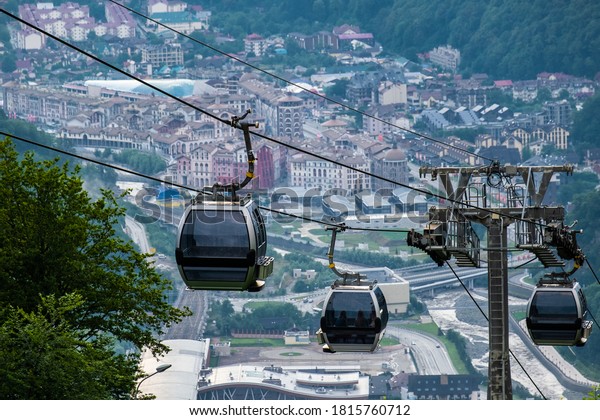 Cable car or gondola to mountain\
peak. Aerial view of Roza Khutor with traditional cable car above\
the city, in Sochi, Russia. Rosa Khutor. Krasnaya\
Polyana