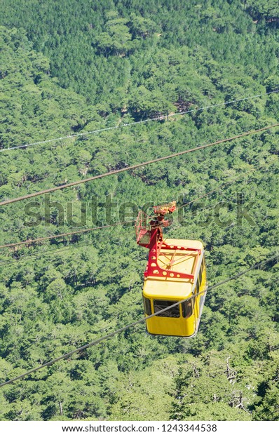 Cable car high above the\
forest. Russia, Republic of Crimea. 06.13.2018. Cable car Mishor -\
Ai-Petri