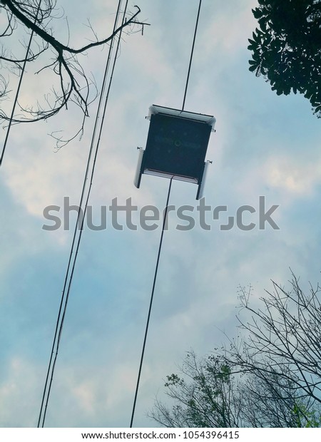 a cable car hung on the\
rope