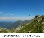 Cable car leaving home cabin on slopes of Aiguille du Midi peak in French Alps