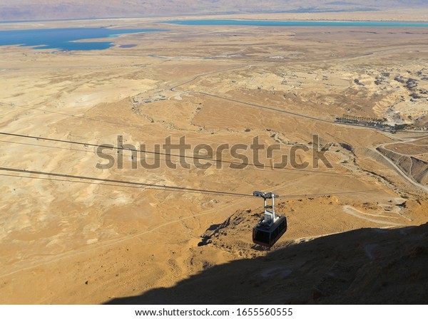 cable car for mass in Israel, landscape to the\
dead seabed.