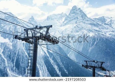 Cable car mechanisms high in the snowy mountains. Activity and tourism. Beautiful landscape. Close-up. 