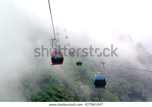 cable car in the middle of fog and mountain and\
selective focus
