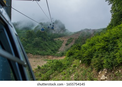 the cable car in the mountains with clouds