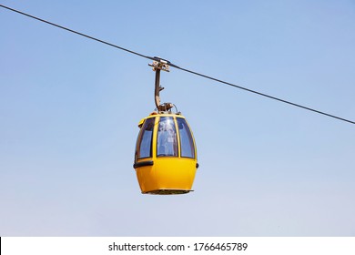 cable car on a partly cloudy blue sky background