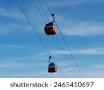 Cable car on ropeway in Piatra Neamt, Romania. Blue sky in the background.