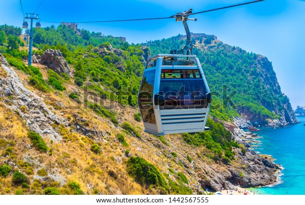 Cable car\
over Cleopatra beach in Alanya, Turkey. The cable car ride\
(funicular) to the top of the castle\
Alanya
