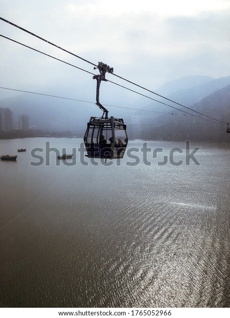 Cable car running between mountains in Lantau\
Island, Hong Kong