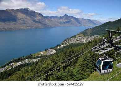 Cable car zipping across the scenic landscape of Lake Wakatipu in Queenstown, New Zealand.
