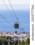 Cable cars seen transitting between Monte which overlooks Funchal and the city of Funchal (the capital of Madeira) seen on 31 July 2024.