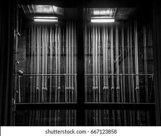 Cable And Chain Rigging Backstage In A Theater. Vertical Lines. Black And White.