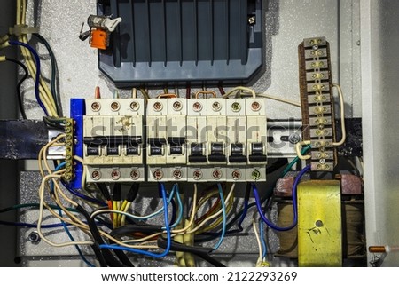 Cable chaos in electric control panel close-up. Tangled wires. Circuit breakers