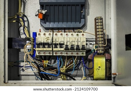 Cable chaos in electric control panel close-up. Tangled wires. Circuit breakers