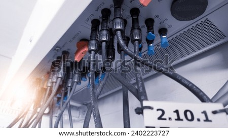Cable connecting the power from the solar panel to the inverter with shiny light. Cable string connection on inverter control solar panel. Socket input supply voltage and Technology of solar energy.