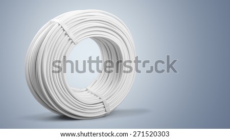 power cable rolled up in a roll, hanging on a brown house wall