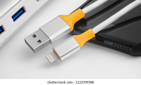 cable for phone with yellow details and gold connectors on two-side lightning - Shutterstock ID 1123709588