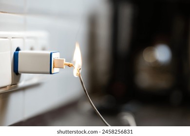 The cable plugged into the socket caught fire. Danger of using a broken cable