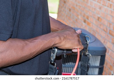 Cable Repair Man Running A Signal Meter Diagnostic On A Coaxial Internet And Video Cable Junction On A Residential Home Façade.