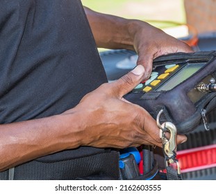 Cable Repair Man Running A Signal Meter Diagnostic On A Coaxial Internet And Video Cable Junction On A Residential Home Façade.